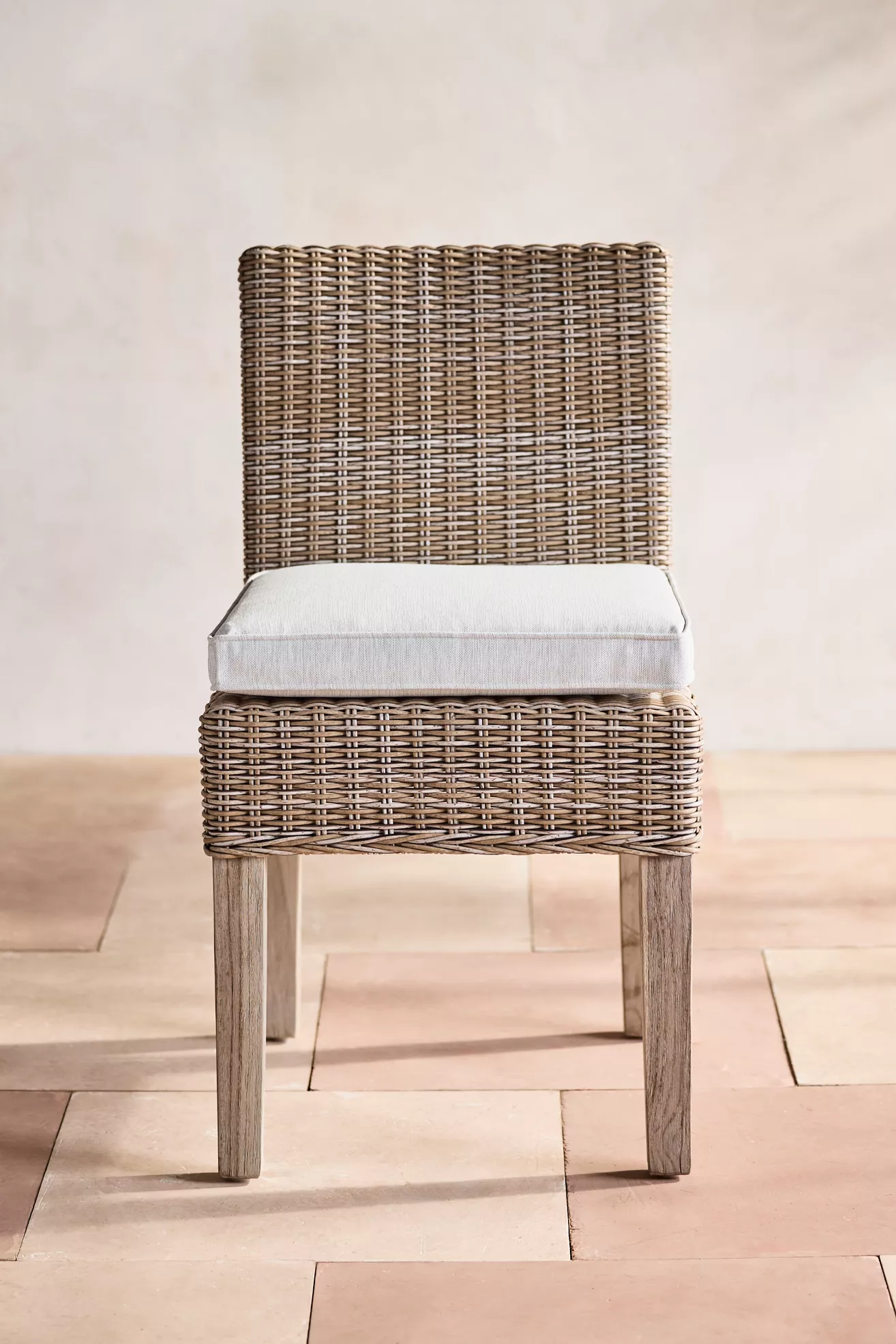 Front view of wicker chair with cushion