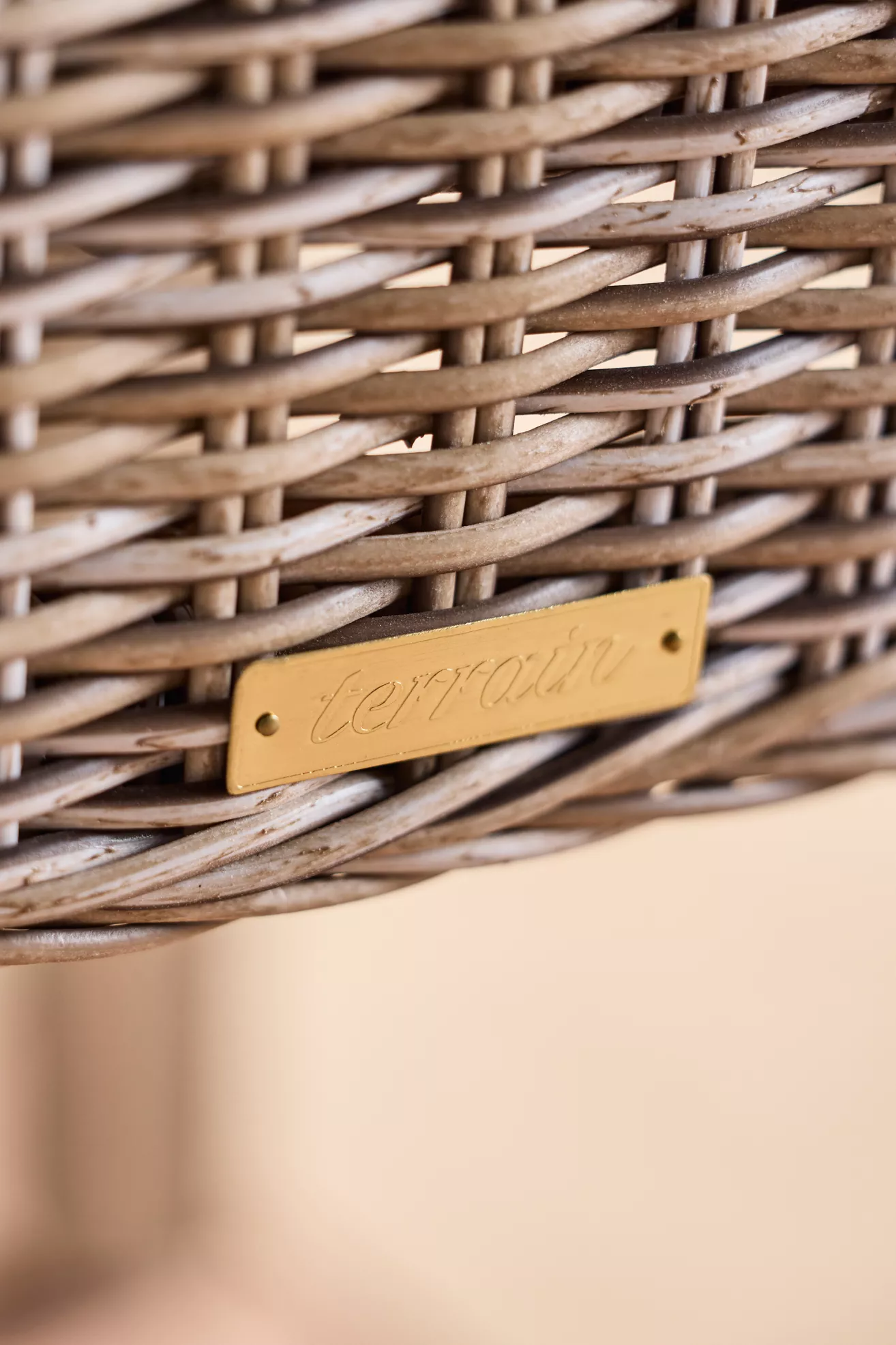 Close-up brand plate on wicker basket chair