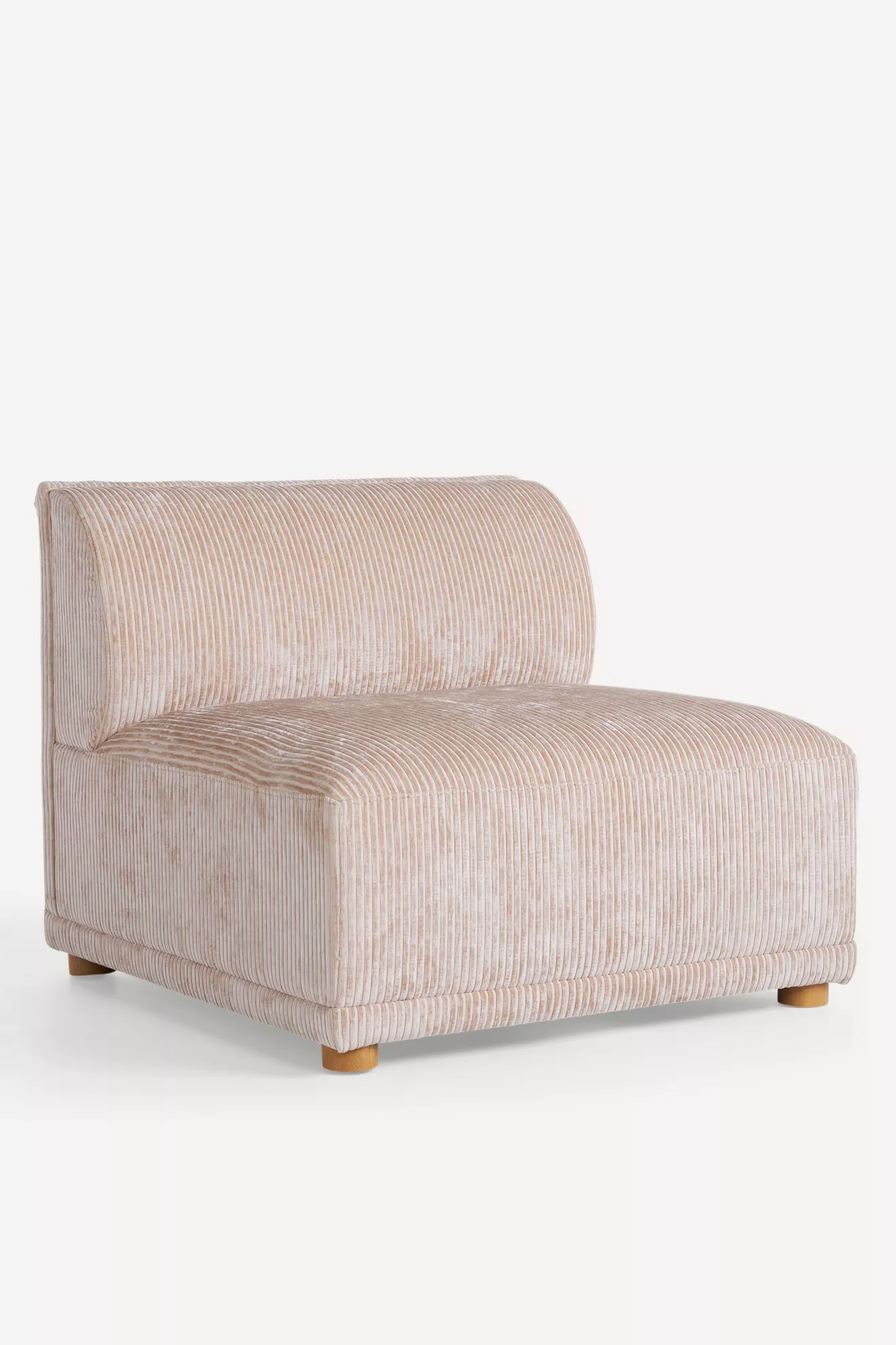 Side view of pink corduroy armless chair showing depth and legs