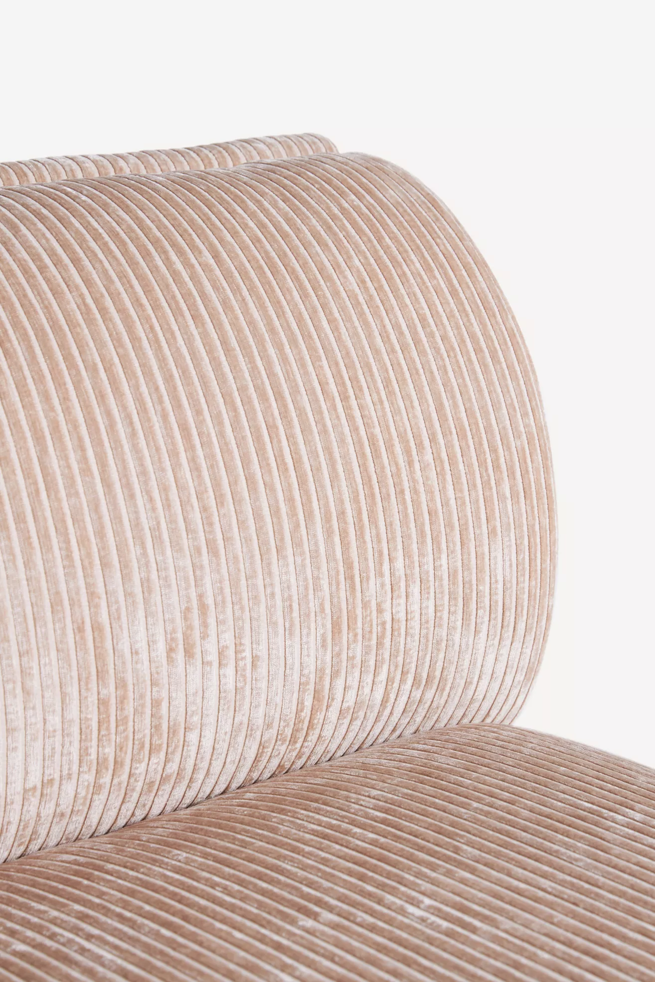 Close-up of corduroy fabric texture with vertical ribs in pink hue