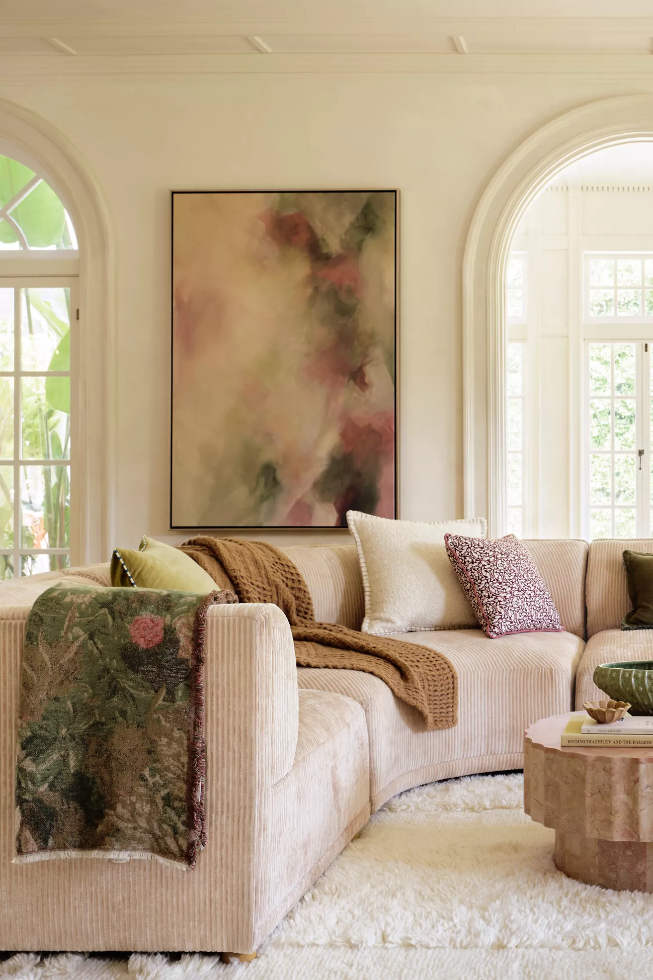 Light beige corduroy modular sofa with corner ottoman in living room.