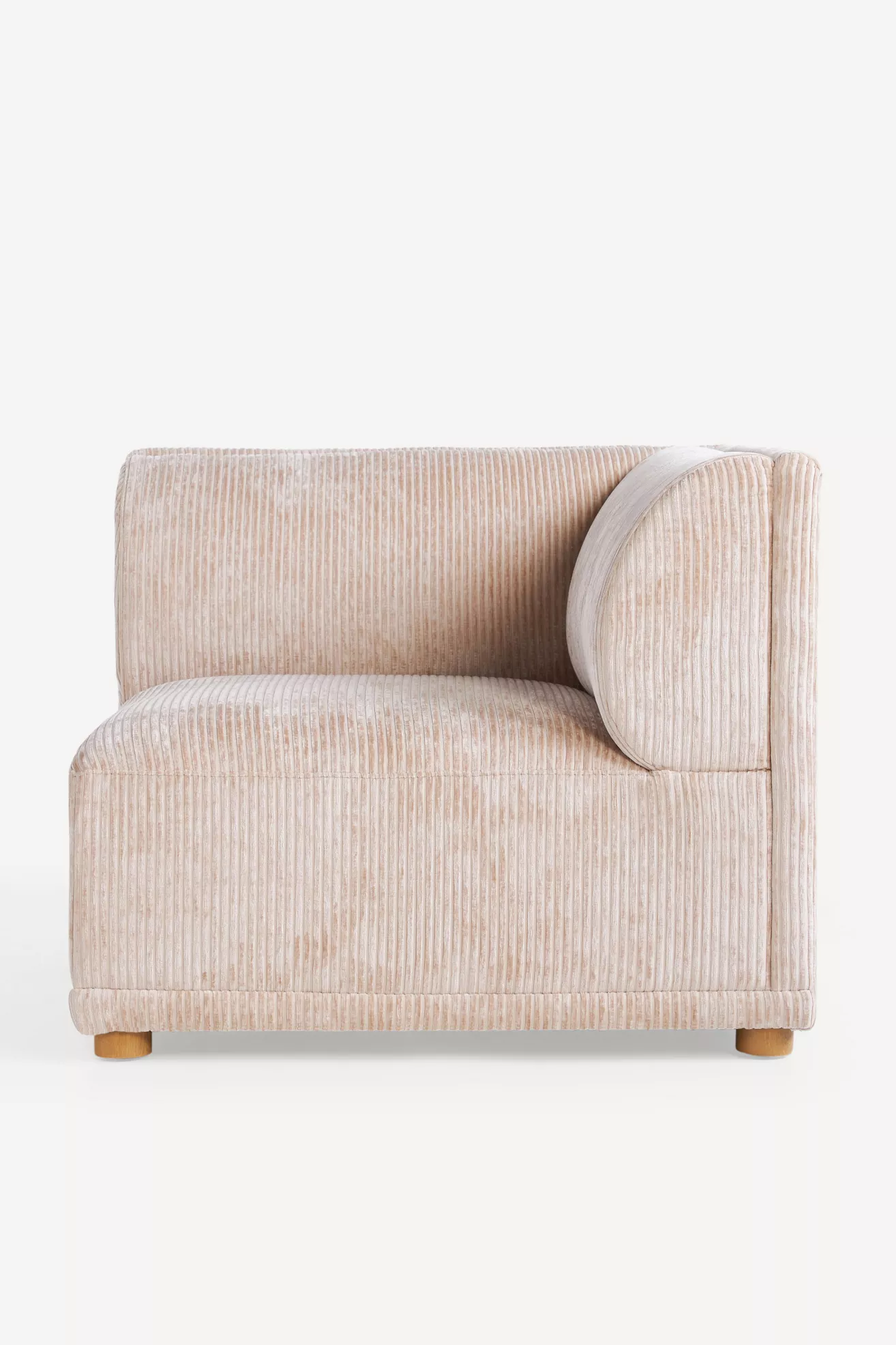 Light beige corduroy modular chair with rounded side panel and short wooden legs.