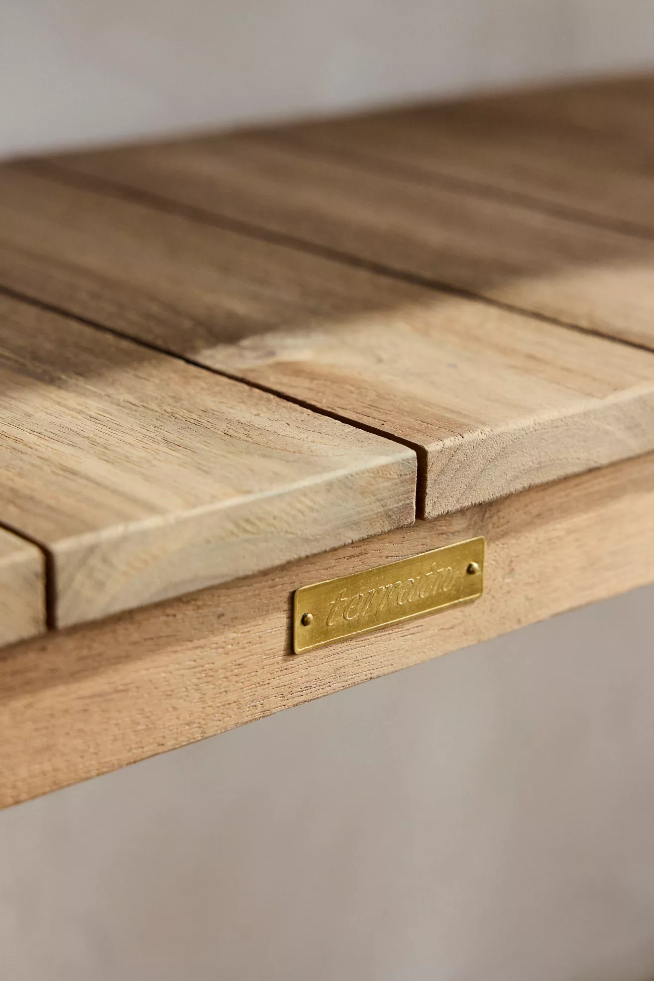 Close-up of tabletop joints and brass plaque