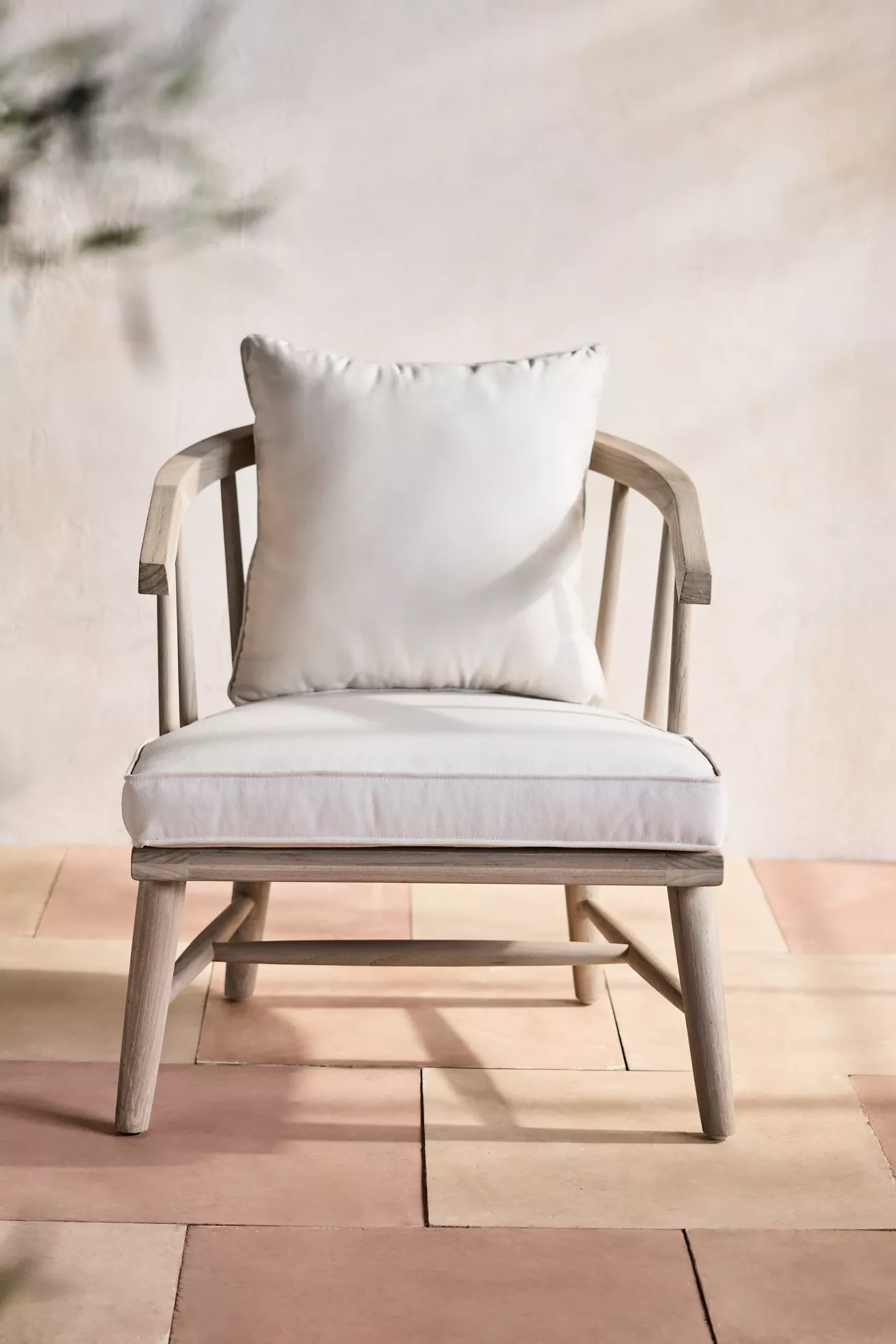 Front-facing view of terrace teak lounge chair with cushions