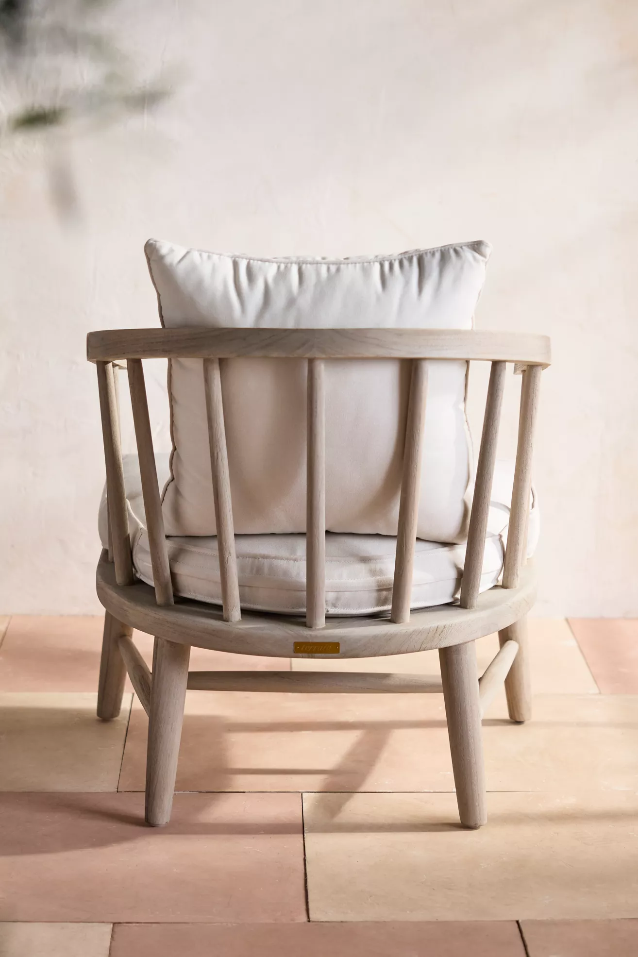 Back view of terrace teak lounge chair with cushions