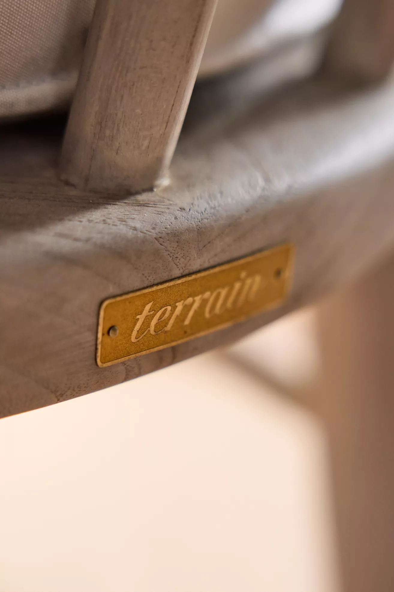 Brand plaque reading 'terrain' on chair