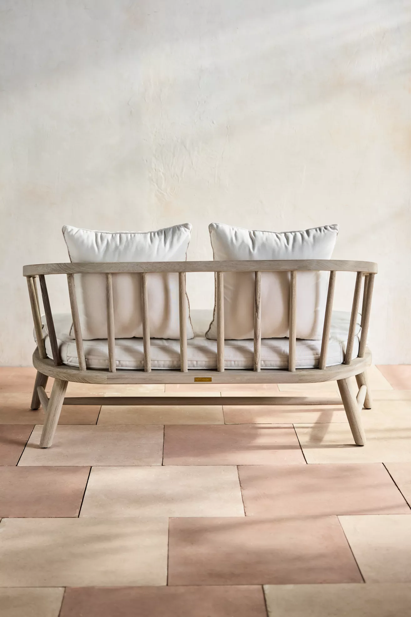 Teak outdoor two-seat sofa back view with cushions