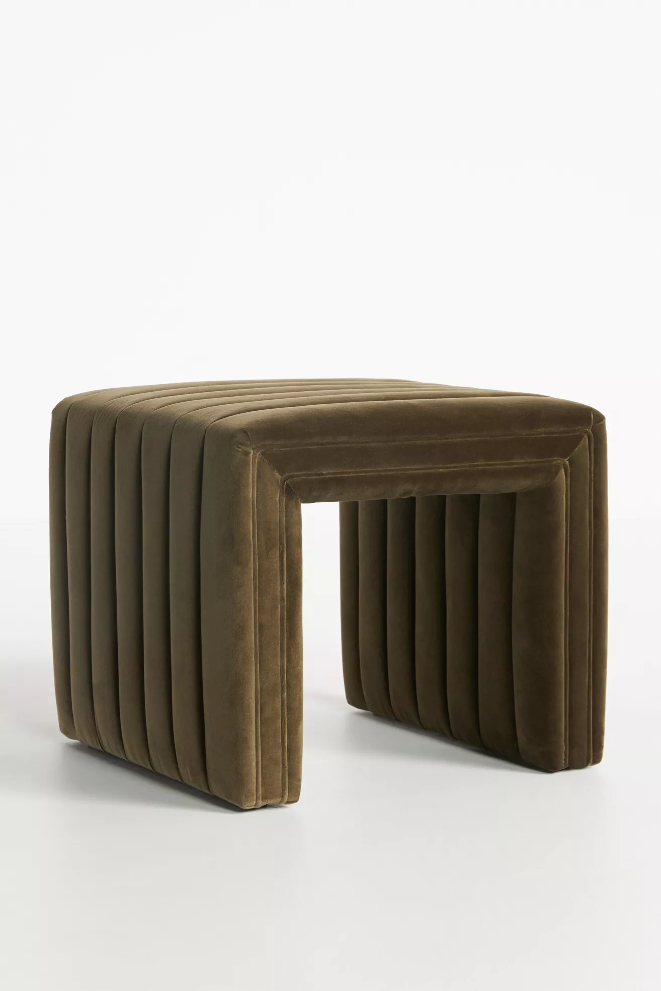 Close-up of velvet upholstery on ottoman showing ribbed channels