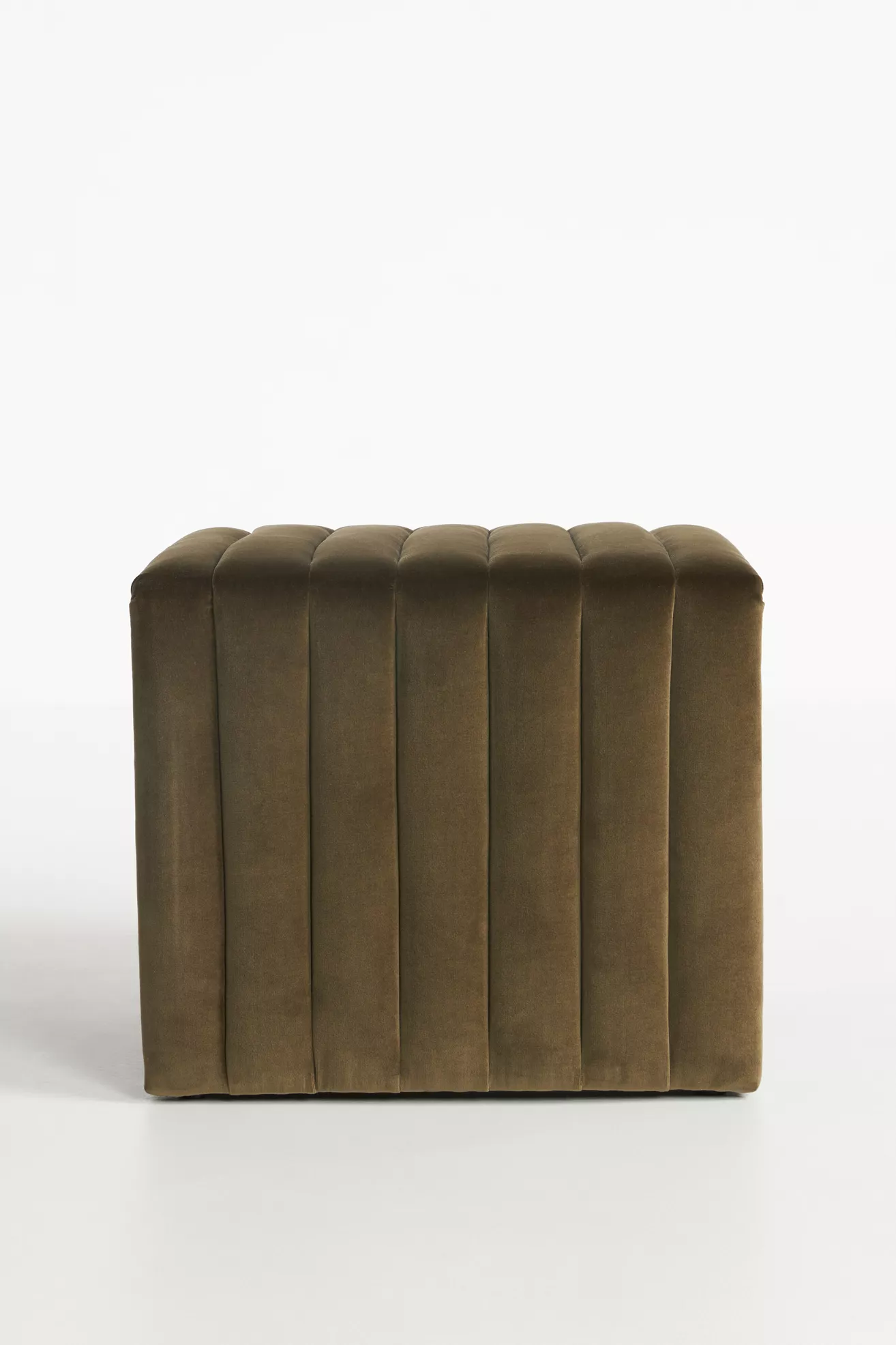Front-facing view of velvet ottoman with vertical channels