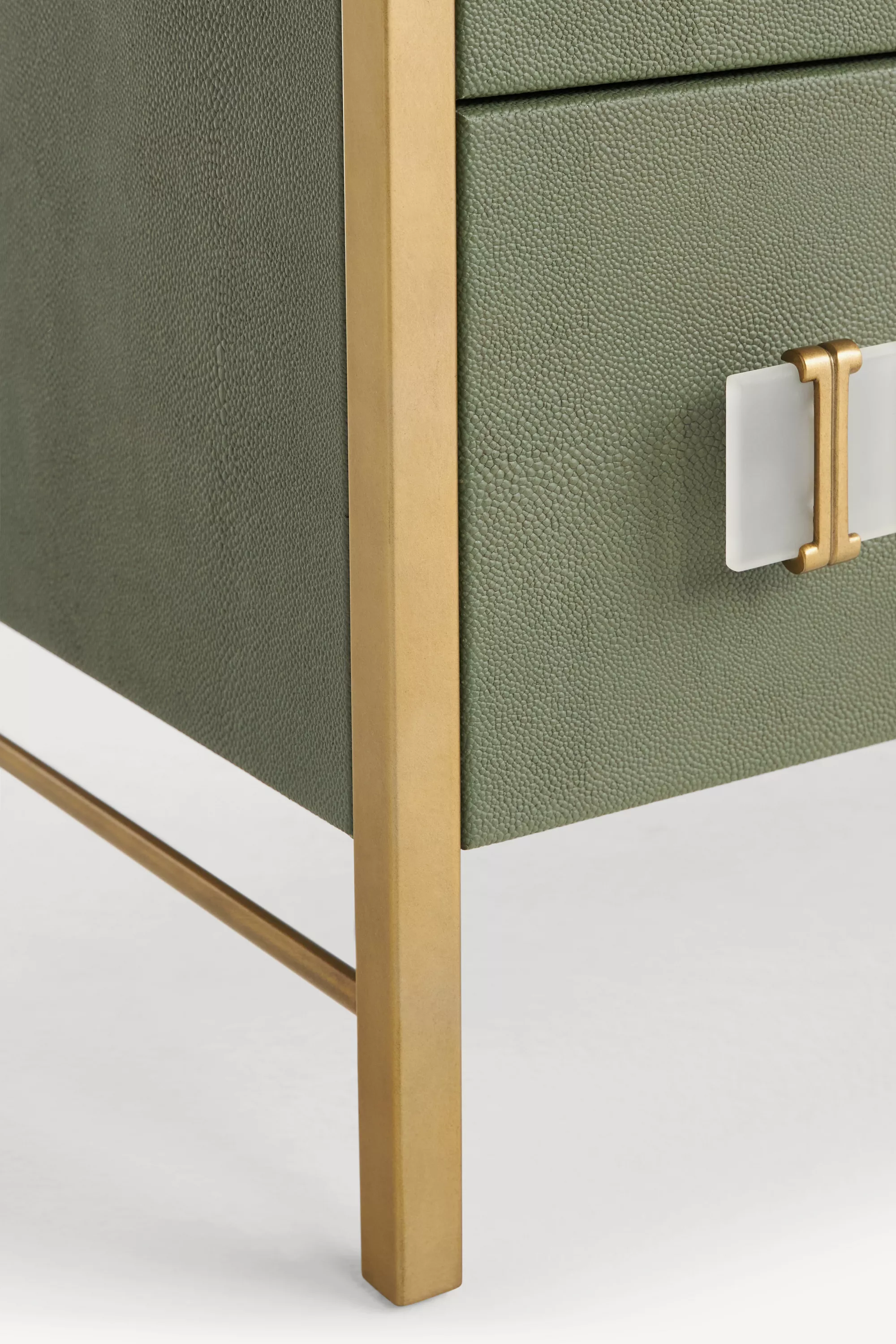Close-up detail of a dresser drawer with gold hardware.