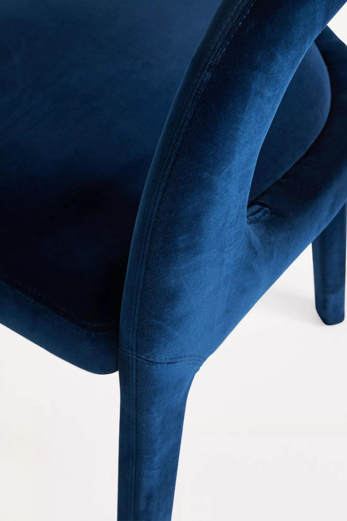 Close-up of navy velvet upholstery and stitching on Hagen chair