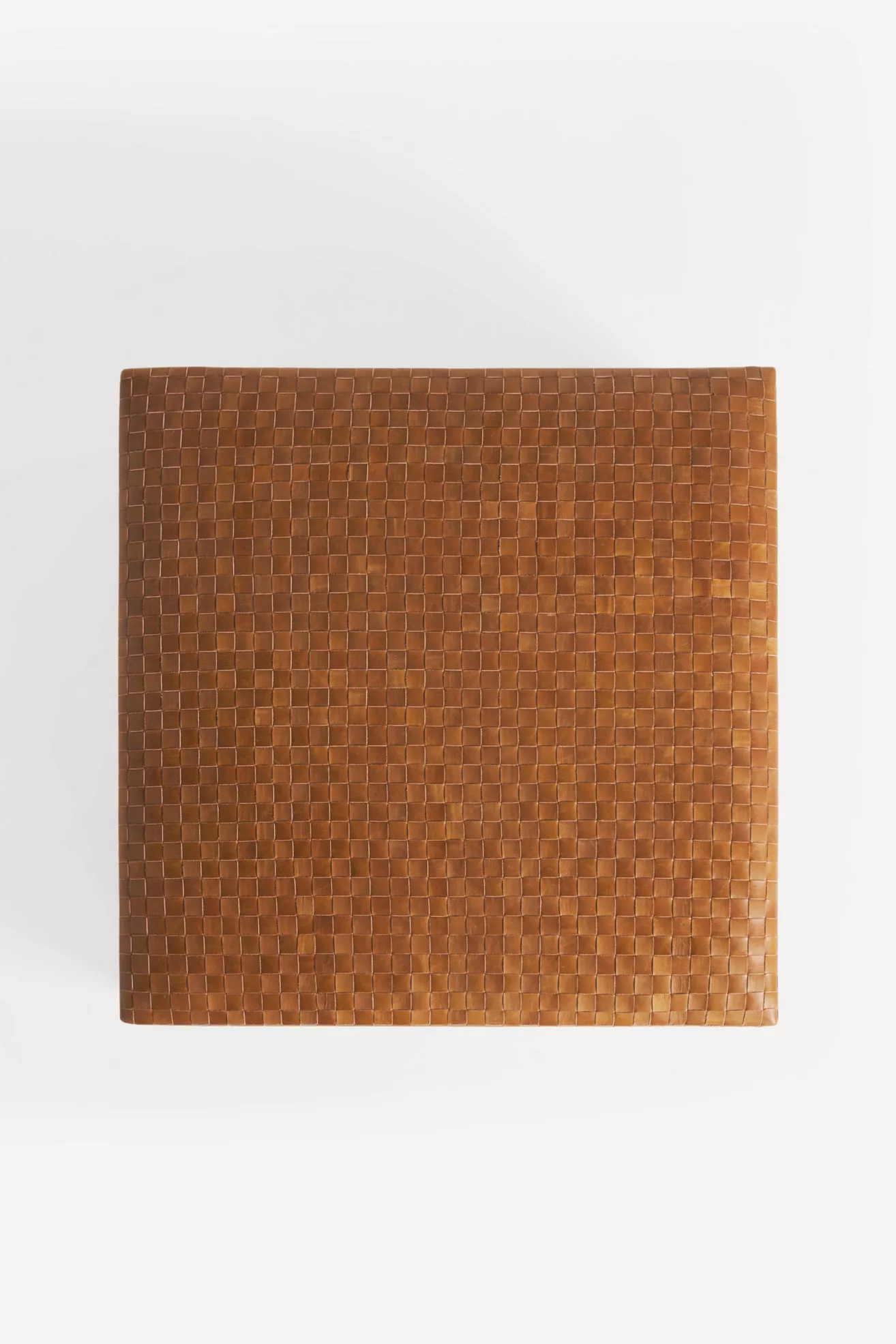 top-down view of woven leather ottoman