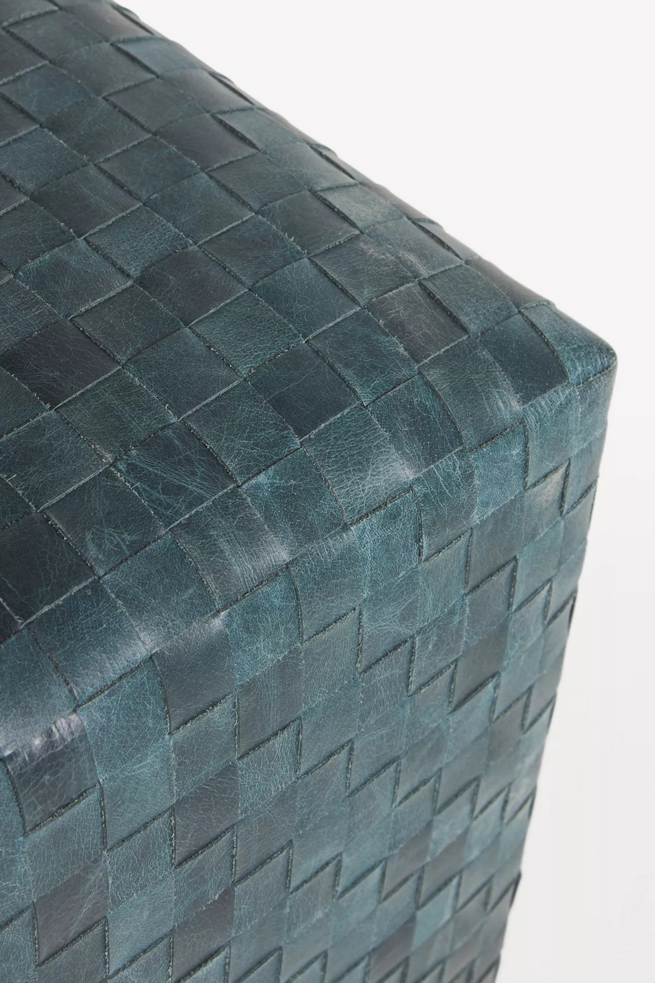 Close-up of teal woven leather showing individual strips and stitching
