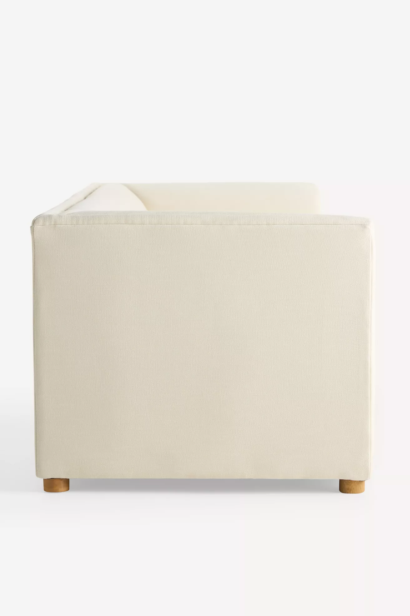 Side view of cream sofa showing its straight lines