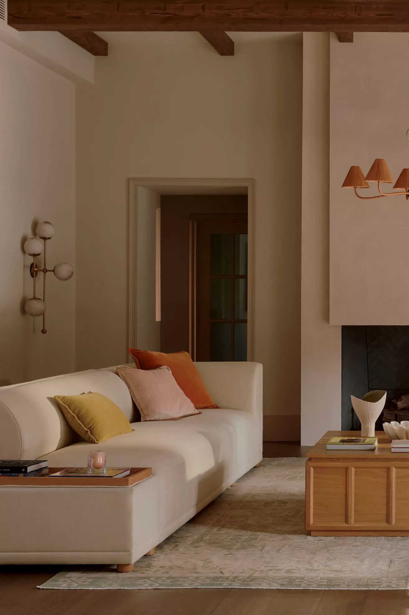 Cream-colored modular armless sofa with colorful throw pillows in living room