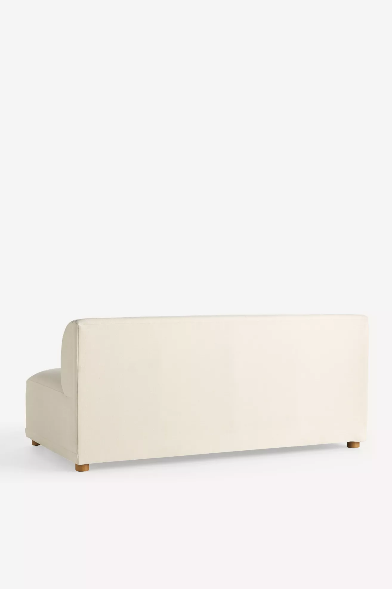 Back view of cream modular sofa showing full back and legs