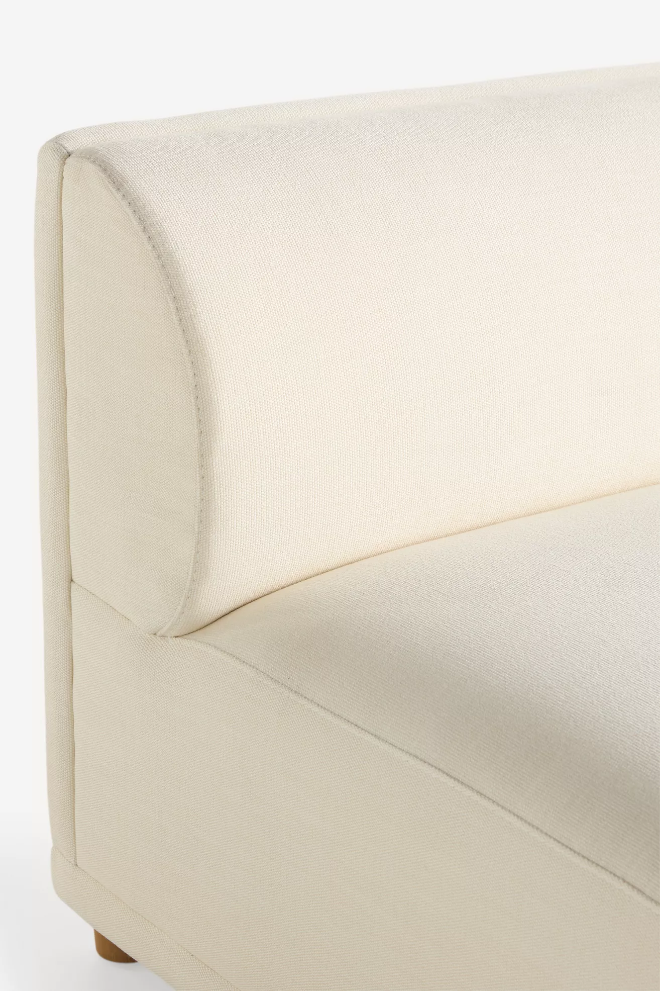 Close-up of rounded corner and stitching on arm