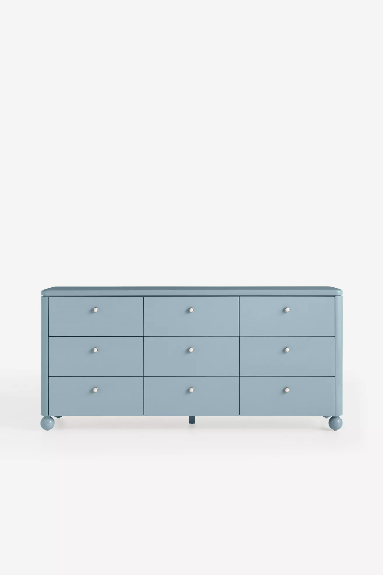 Blue dresser from front view with nine drawers and small gold knobs