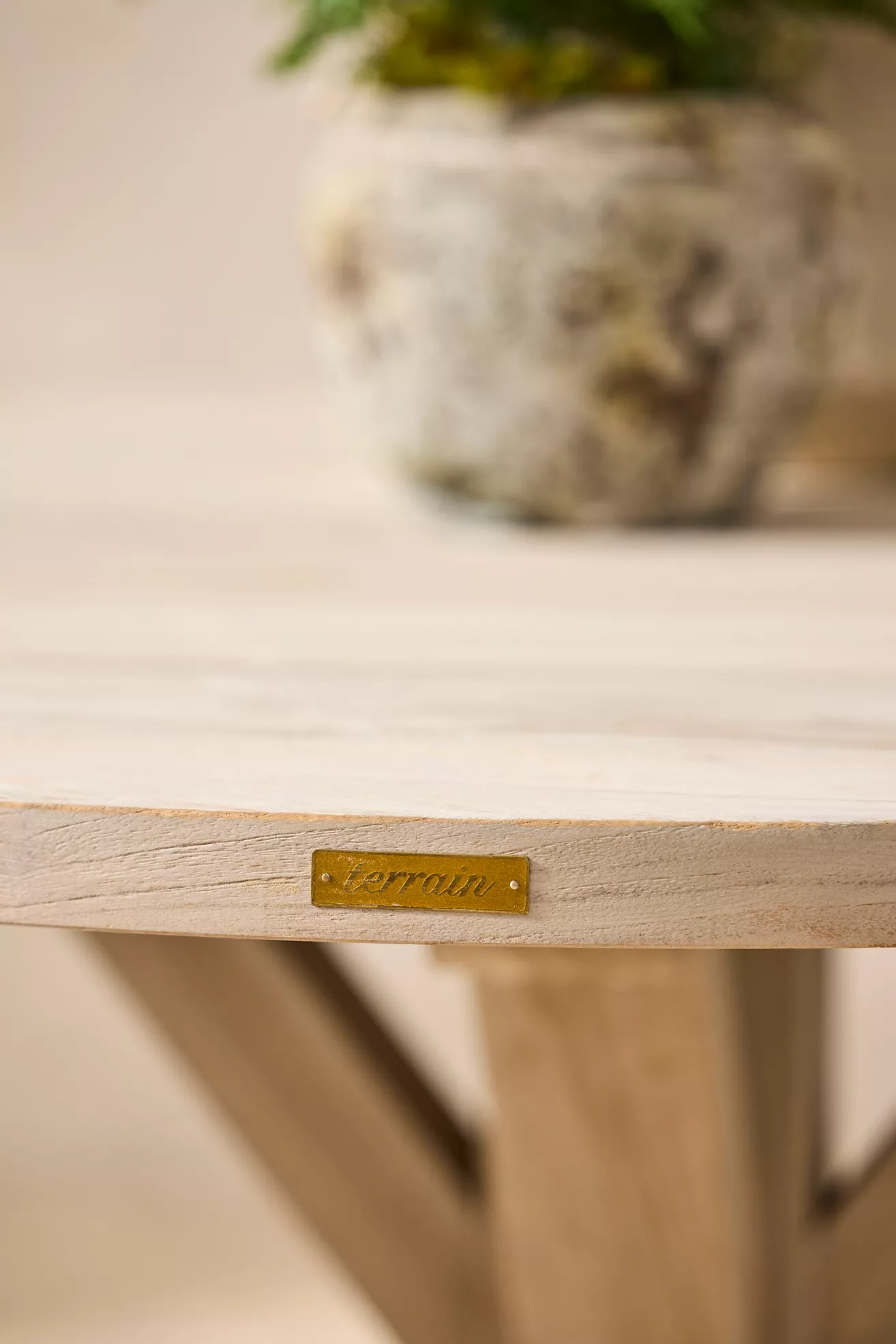 Teak dining table top edge with brand label