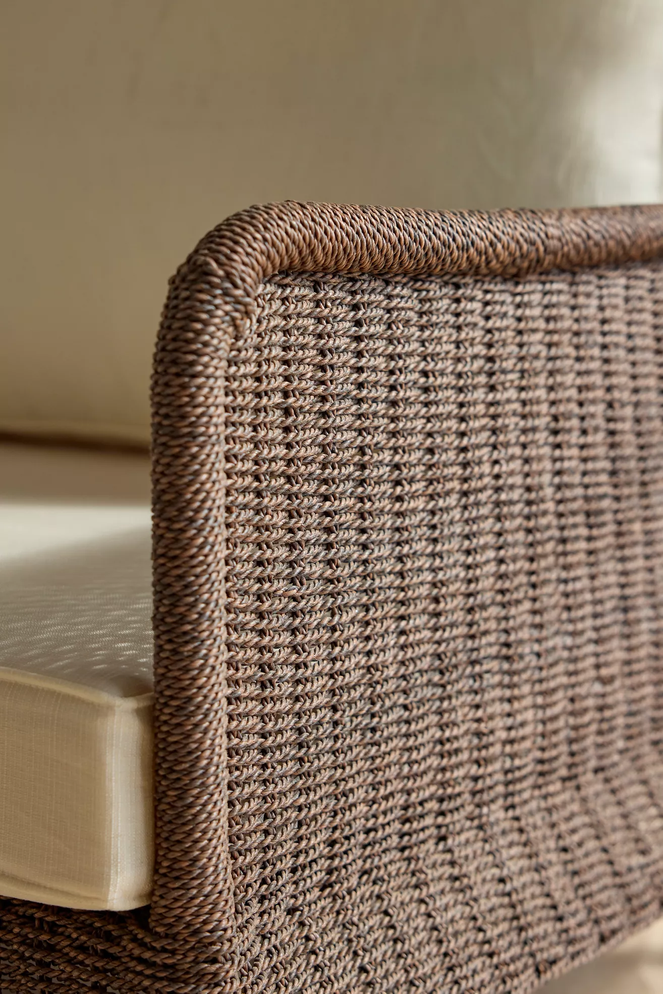 Close-up of the woven wicker texture and corner of outdoor sofa