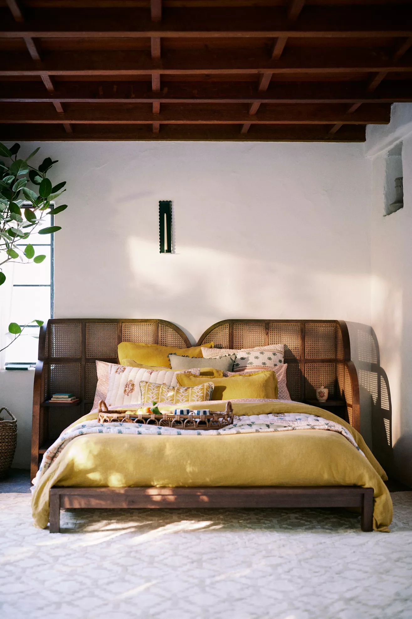 Bedroom with rattan bed and yellow accents