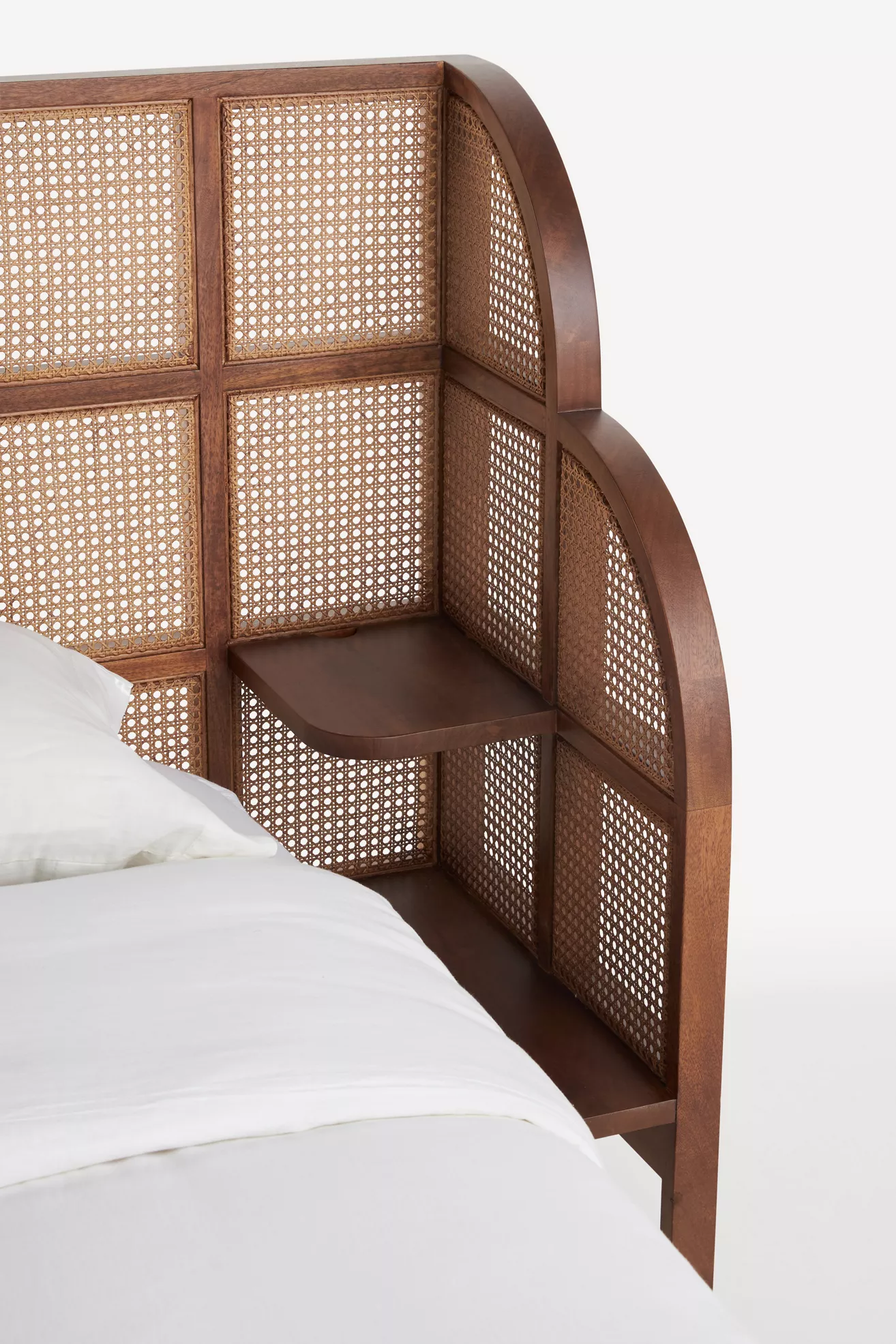 Close-up of headboard curved edge and cane panels