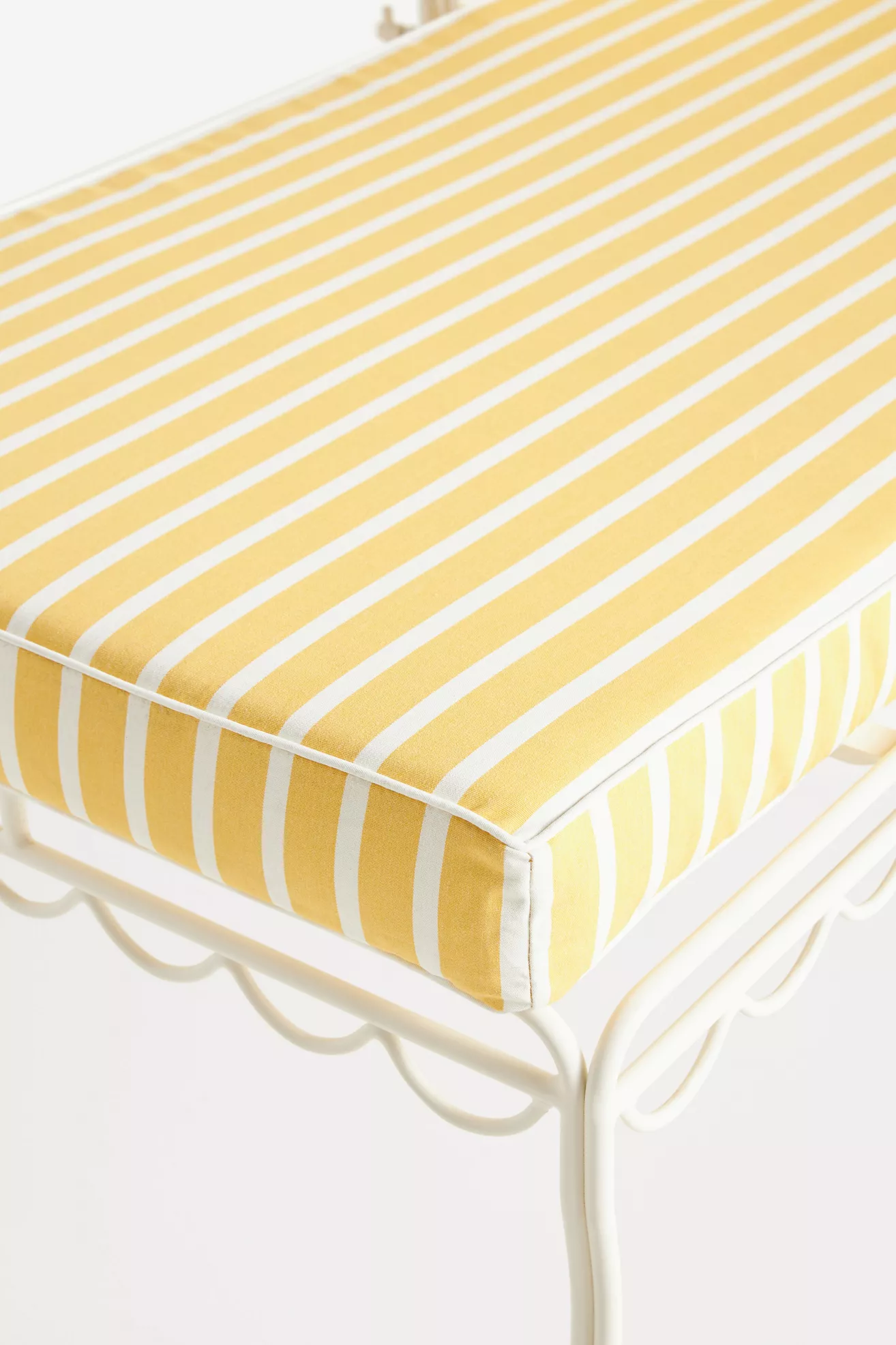 Close-up of yellow and white striped cushion fabric on sun lounger