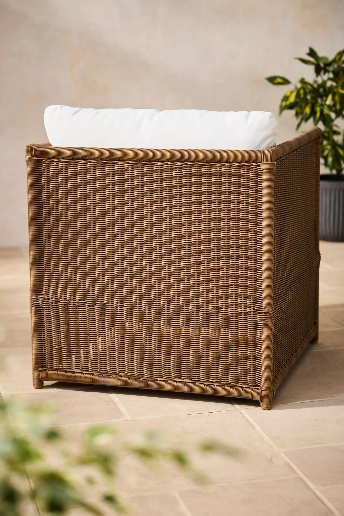 Back view of wicker lounge chair with white back cushion