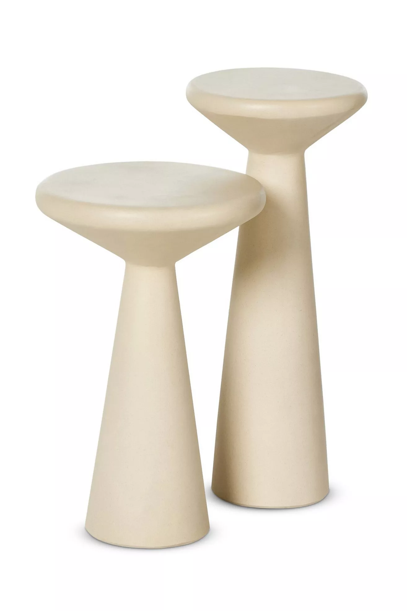 Close view of two beige pedestal tables with round tops