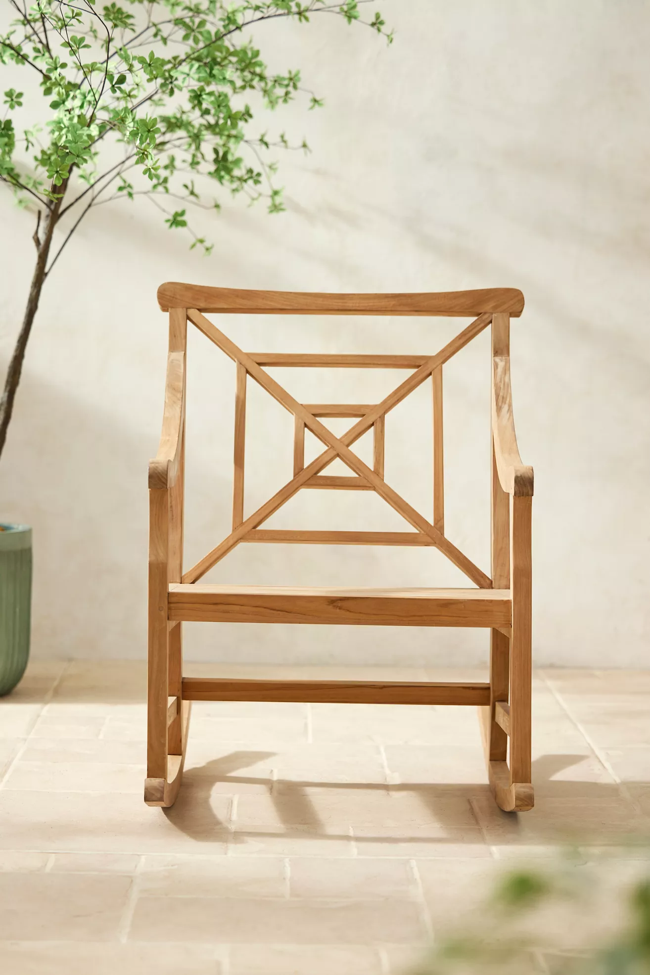 Front-on view of teak fretwork rocking chair