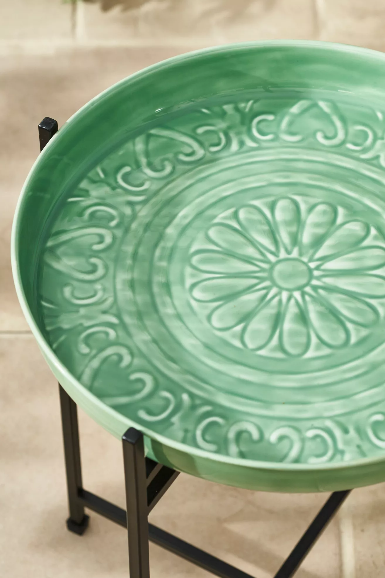 Close-up of green tray top with embossed floral pattern