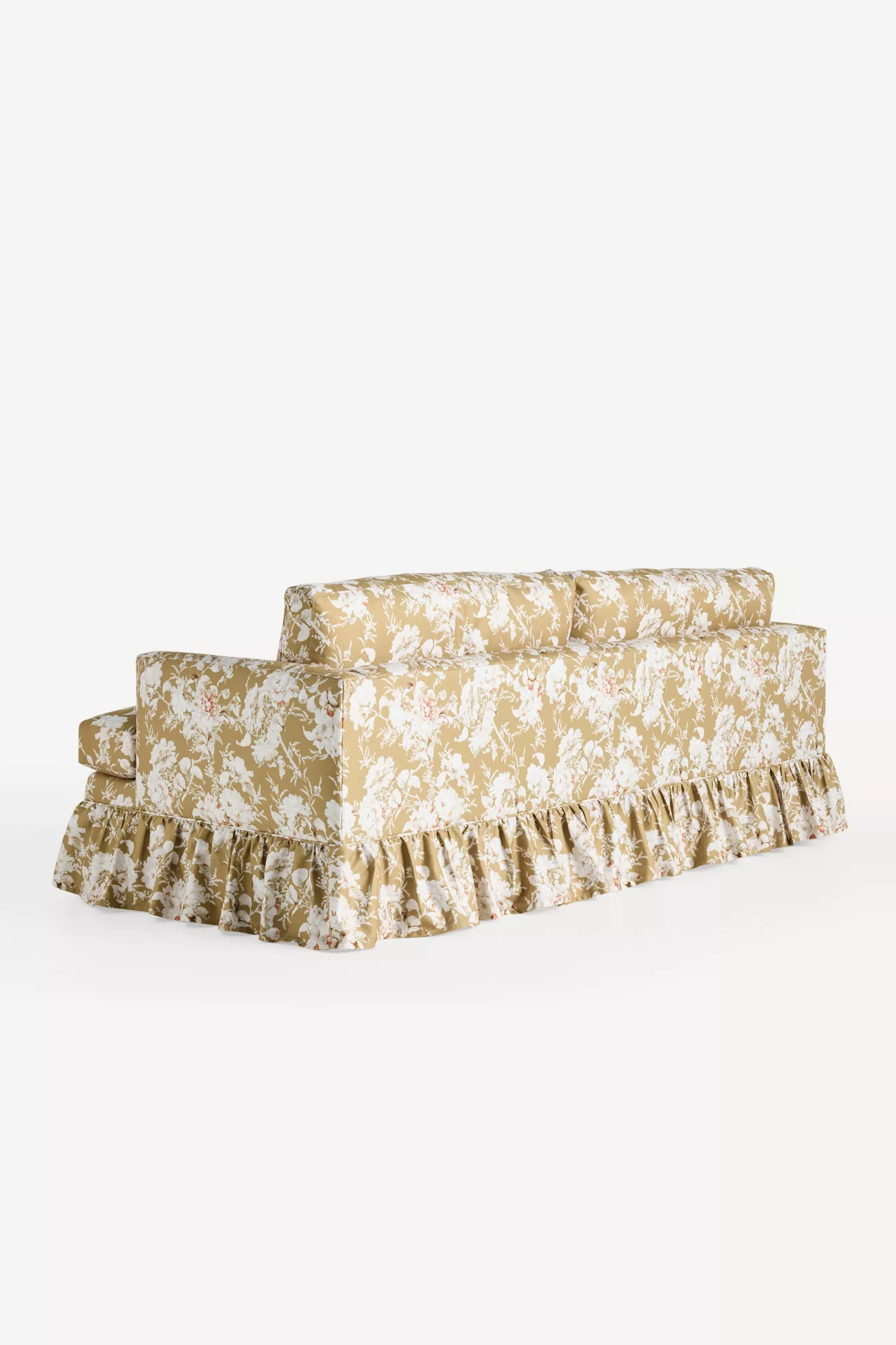 Golden floral ruffle sofa against white backdrop