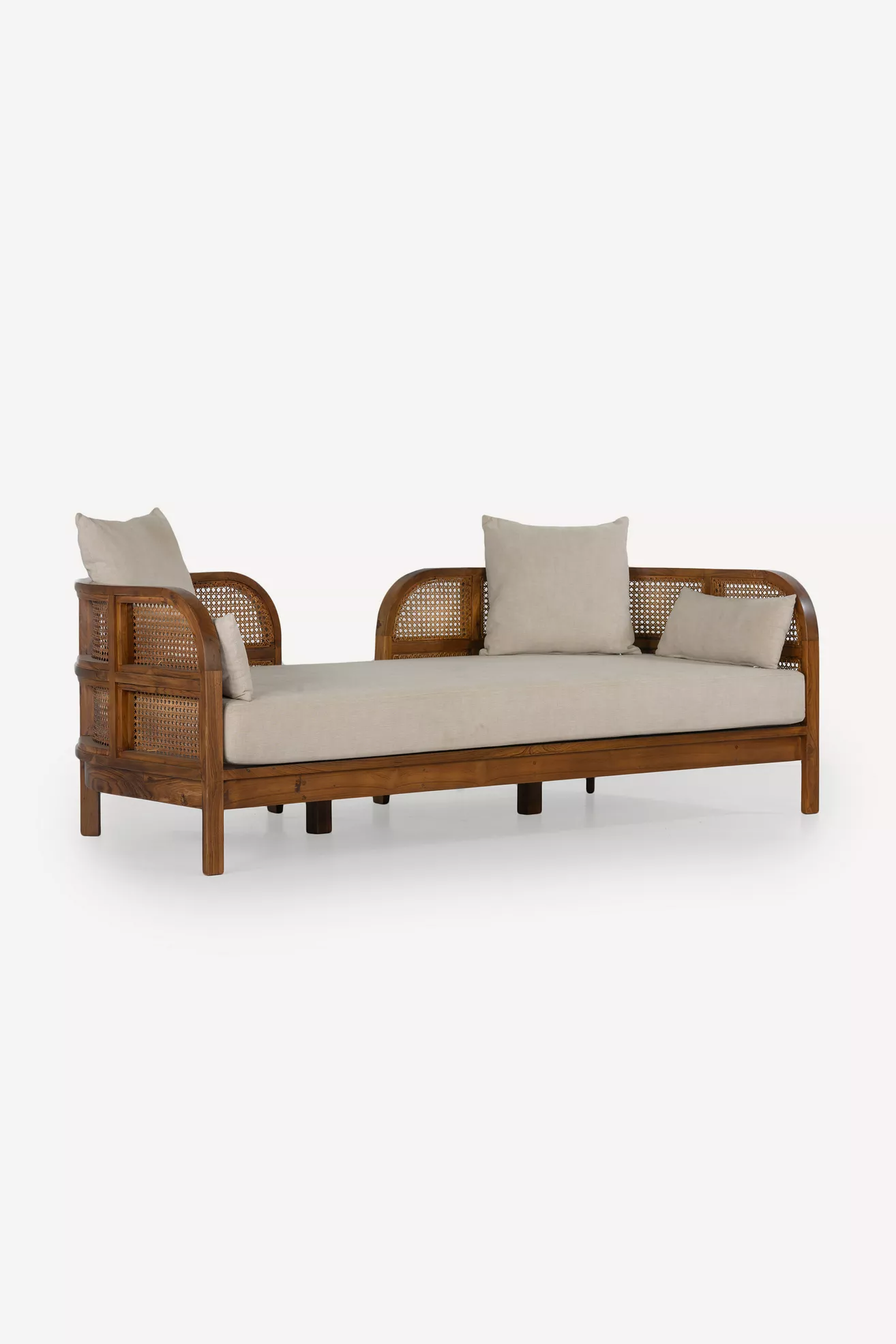 Three-quarter view of the Nest 82" Linen Daybed showing side and back cane panels