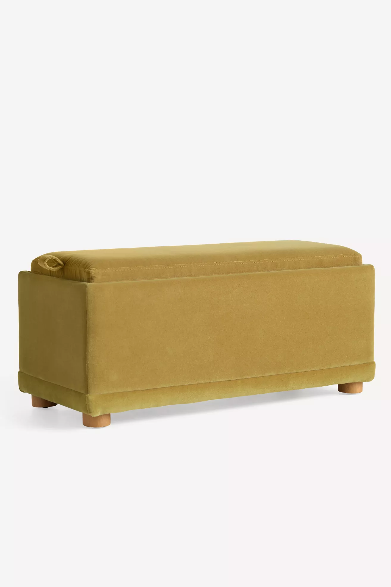 Side/back view of mustard velvet storage ottoman showing stitching and legs