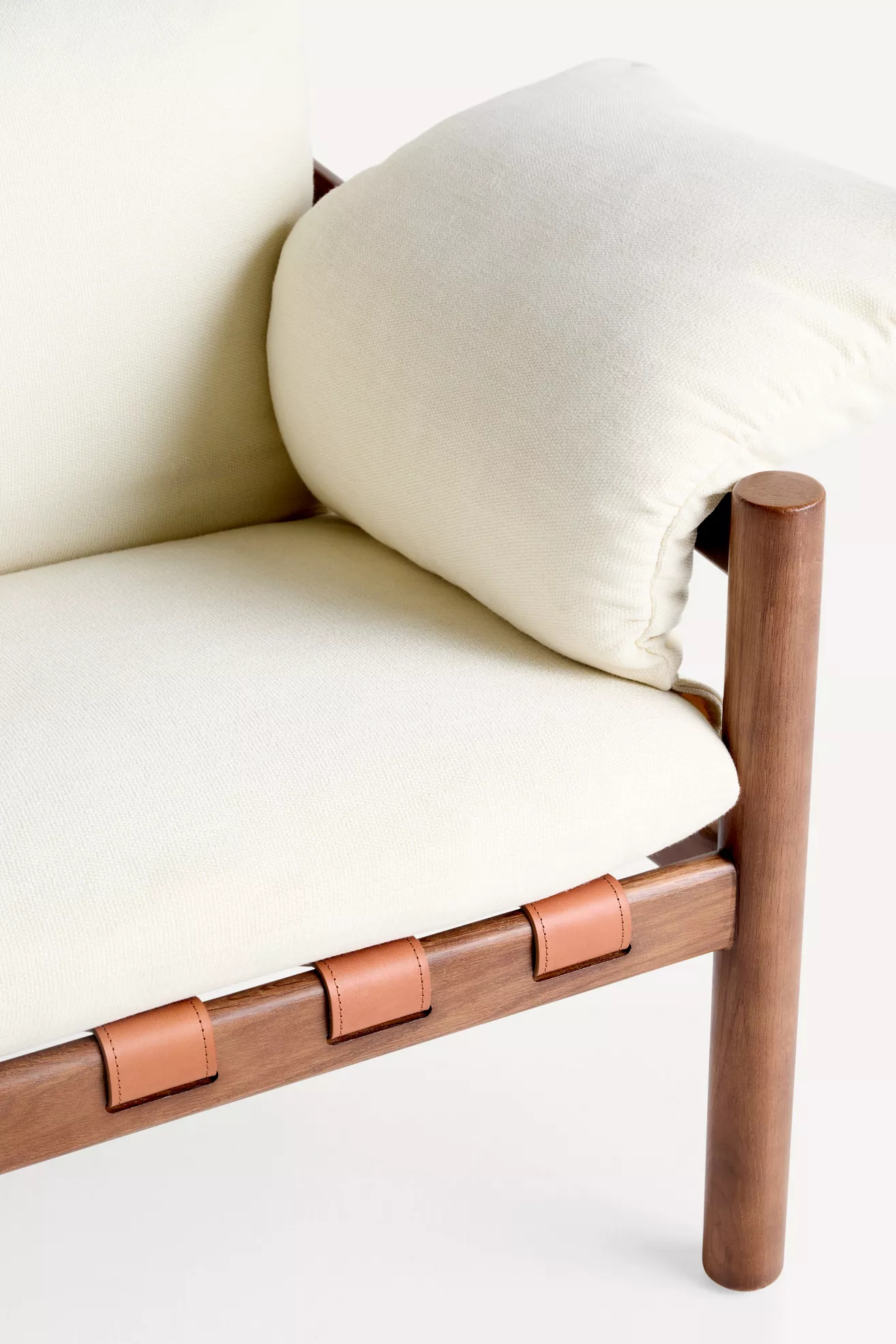 Close-up of armrest/cushion junction with leather strap