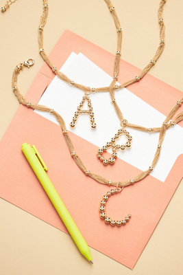 By Anthropologie Beaded Letter Monogram Necklace In Alphabet