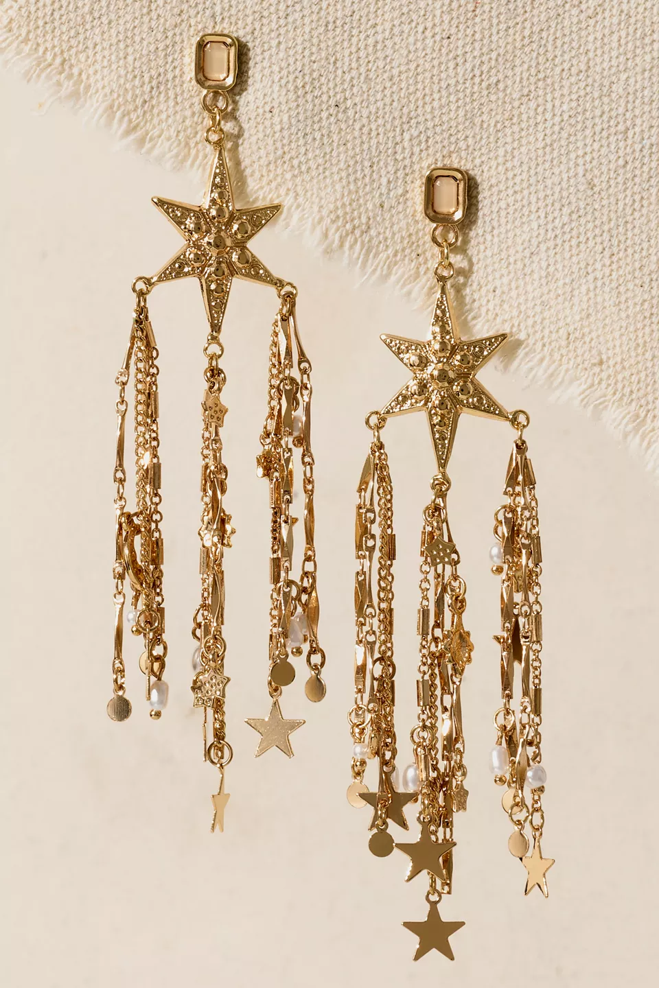 A pair of gold dangling earrings