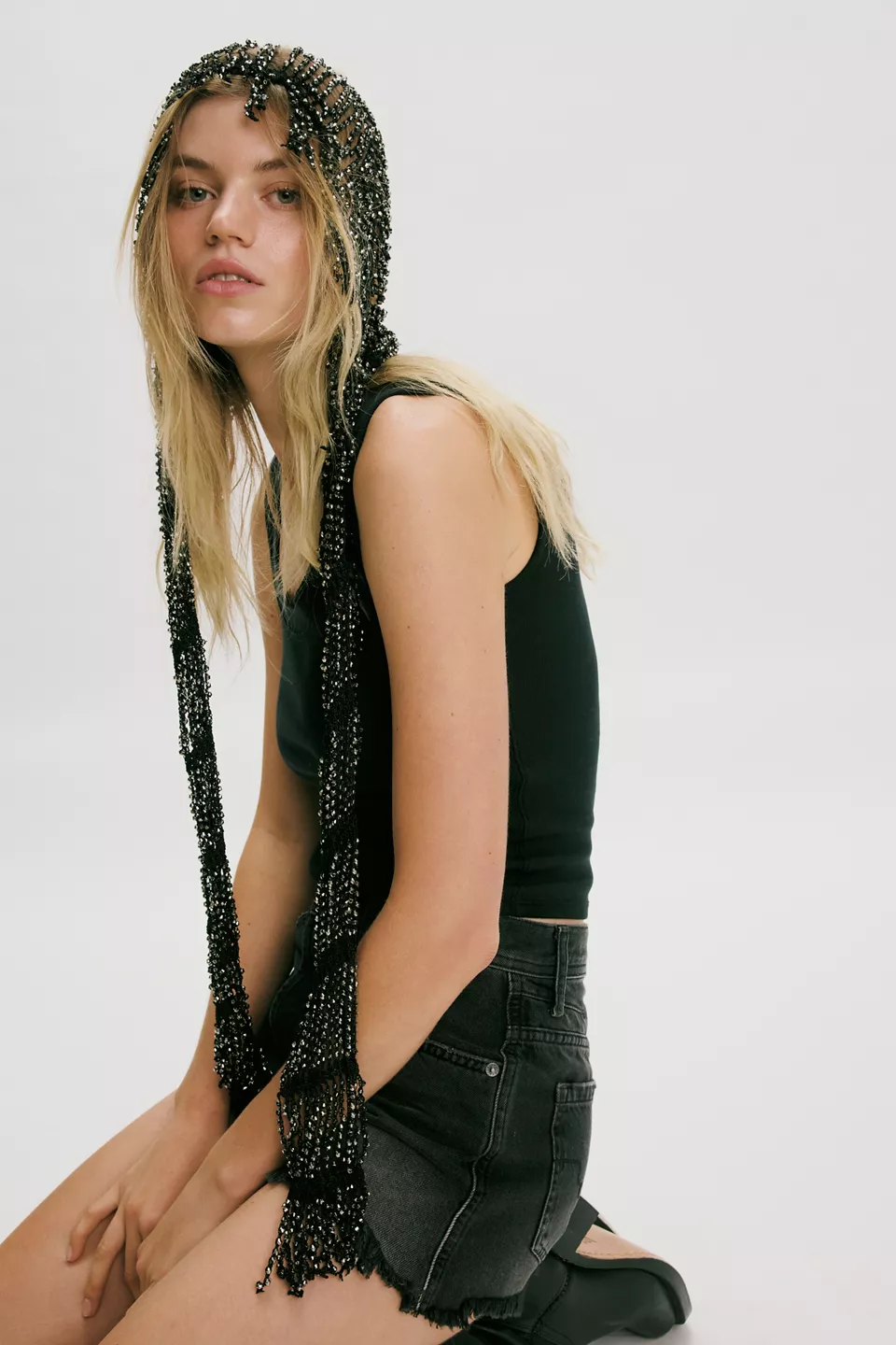 A woman wearing a black fringe hair scarf