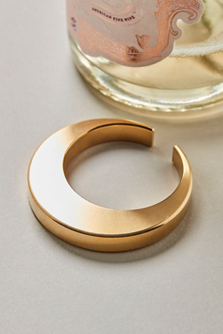 Crescent Moon Bottle Opener at Free People in Gold