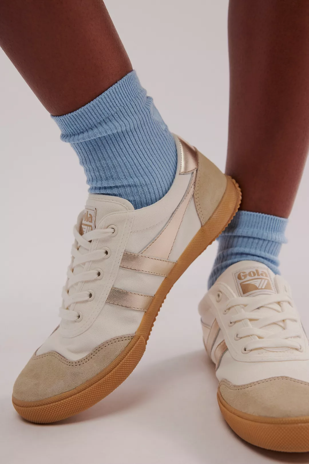 Inspired by retro indoor court-sport styles, these sleek sneakers from Gola feature suede overlays and a rigid outsole, now with shining metallic stripes for a glimmering touch.