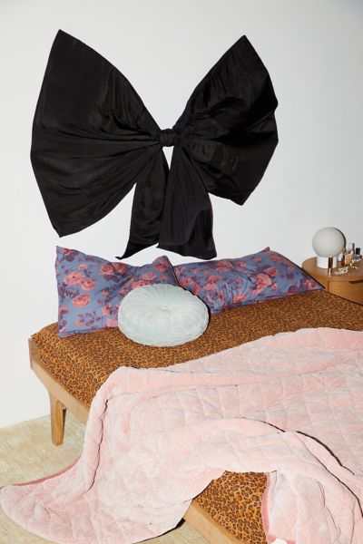 URBAN OUTFITTERS SILKY BOW UPHOLSTERED FLOATING HEADBOARD IN BLACK AT URBAN OUTFITTERS 
