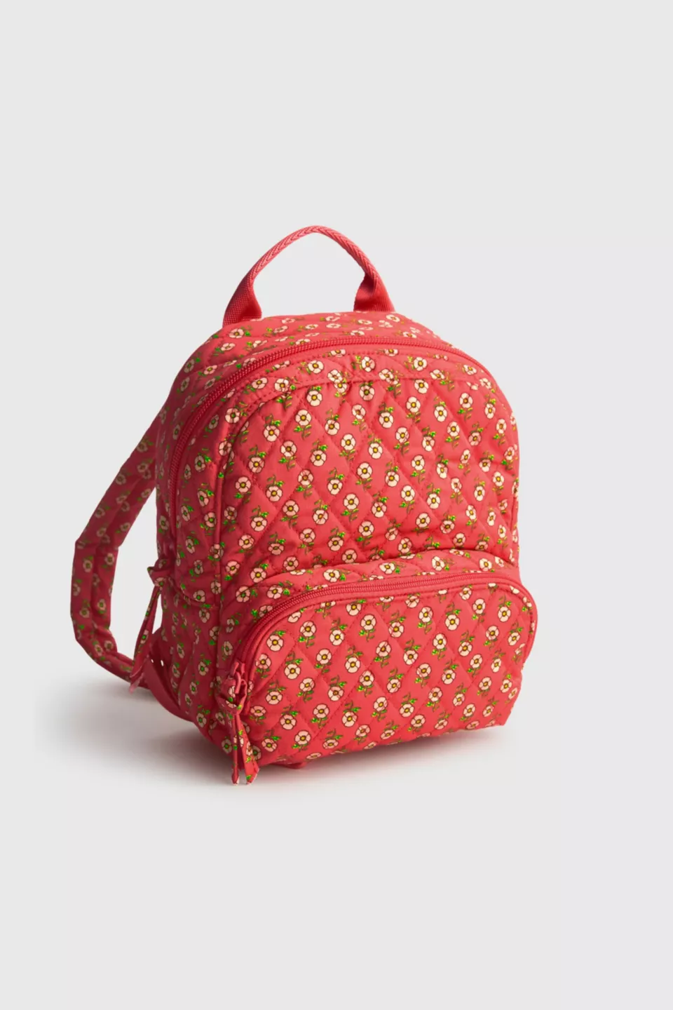 A pink mini backpack with a floral pattern