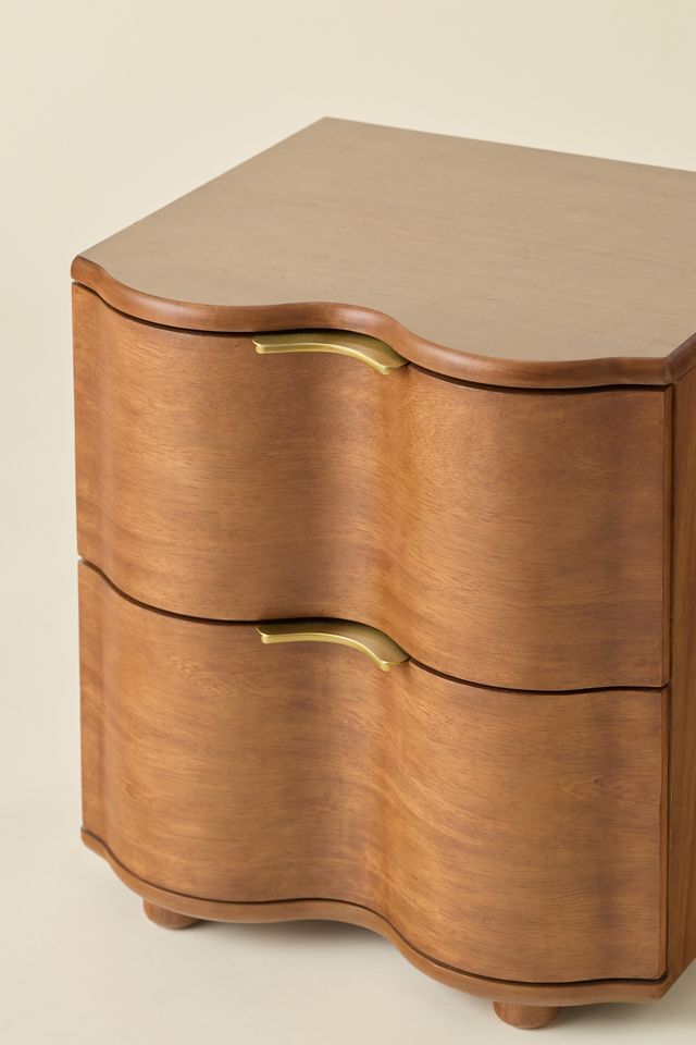 Close-up of curved drawer front and brass handle