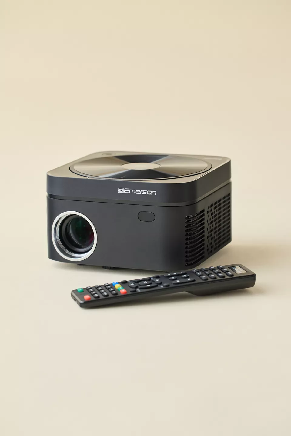 A black projector with a remote