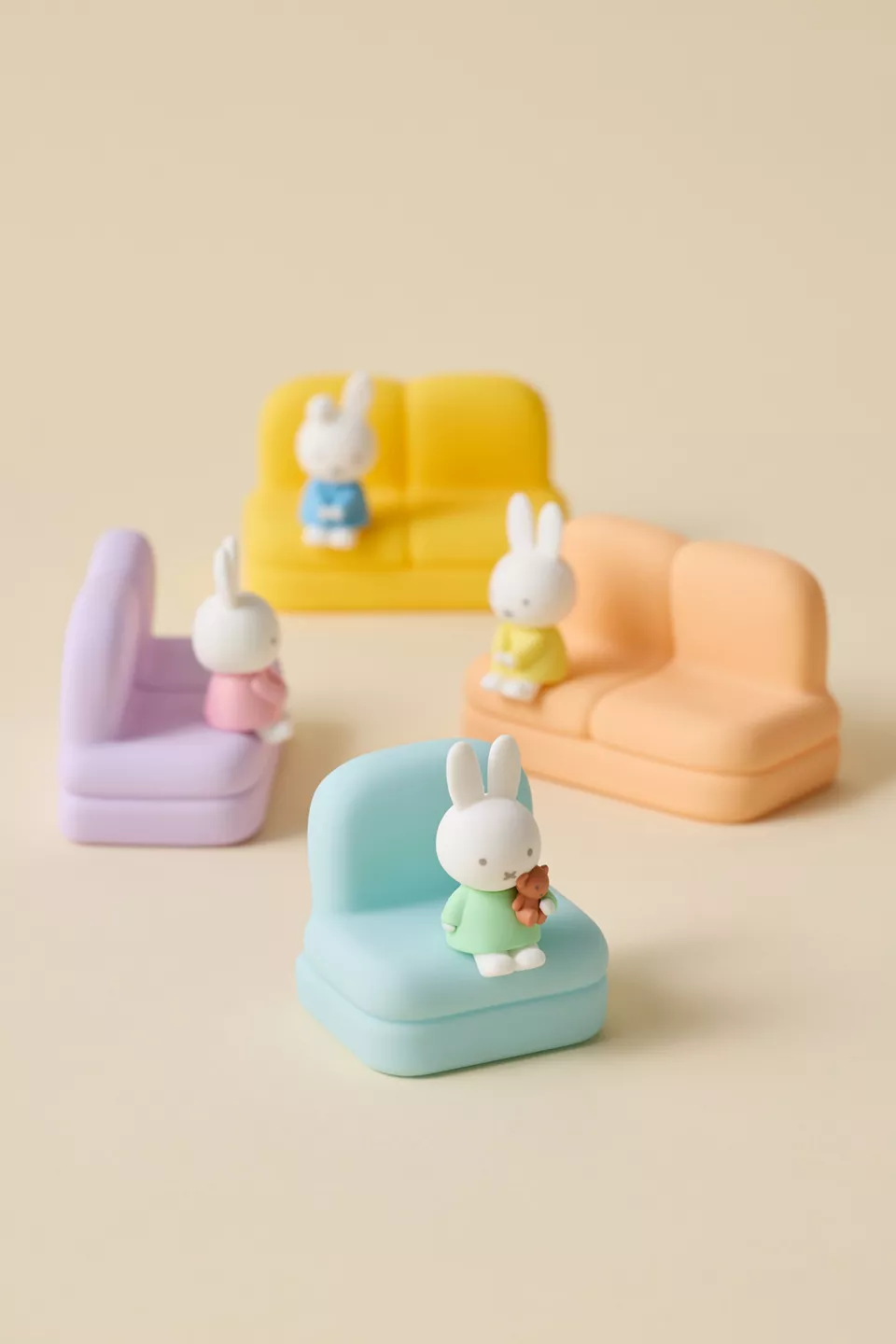 Four different colored sofa shaped phone stands