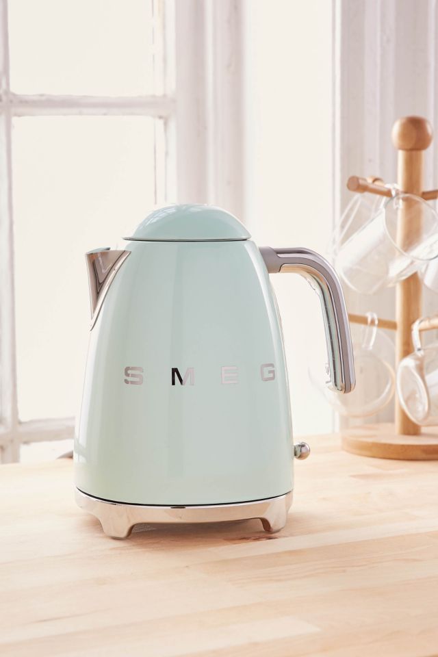 Green electric kettle SMEG for boiling water and making tea or coffee on  table in hotel as design element. Household kitchen appliances for makes  hot drinks. Moscow - July, 2022. Stock Photo