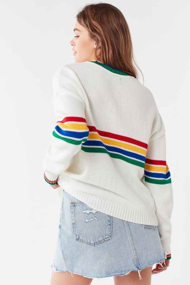 White sweater store with rainbow stripe