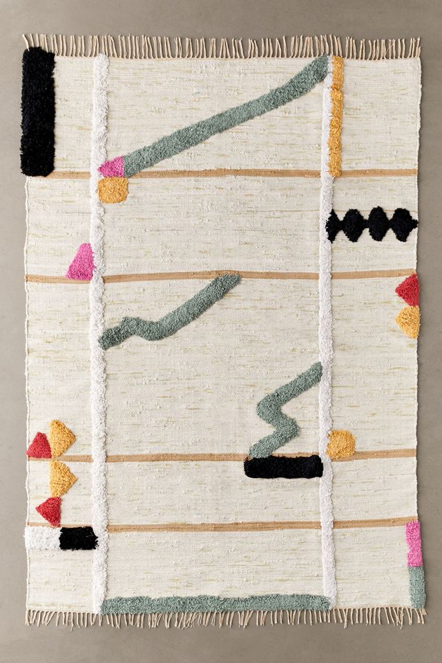 Small tufted rug with mint green, pink, black, red, and yellow organic shapes
