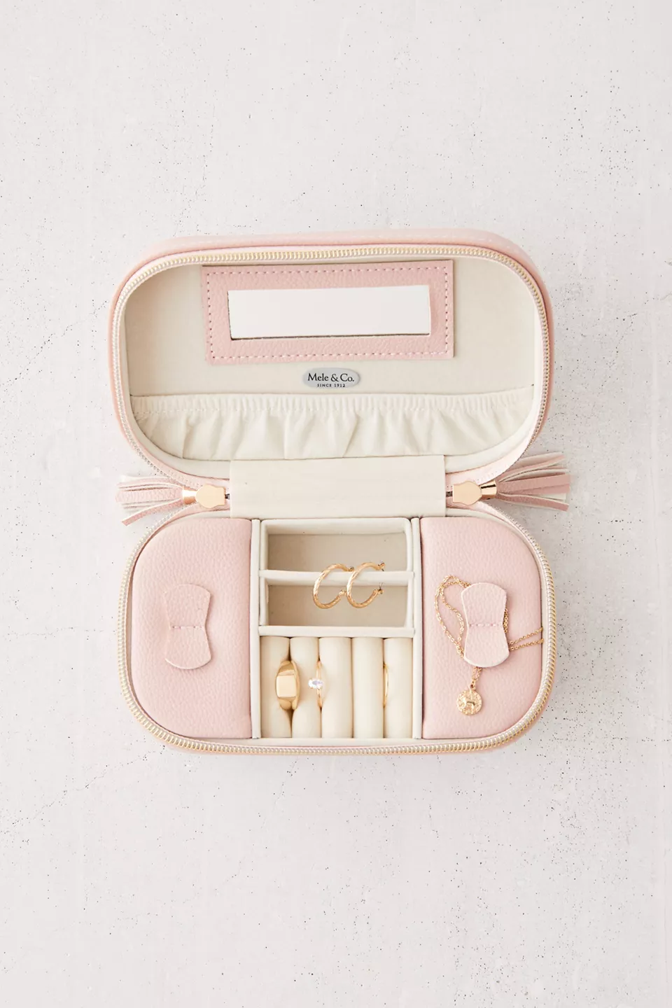 An open pink travel jewelry box