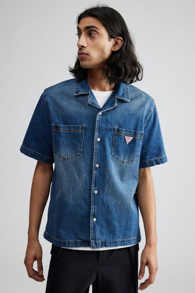 Shop Guess Originals Herringbone Denim Short Sleeve Button-down Shirt Top In Tinted Denim, Men's At Urban Outfitters